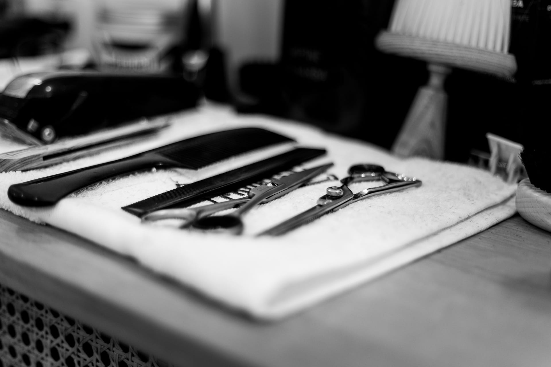 Classic shaving razors and brushes laid out on a barbershop towel